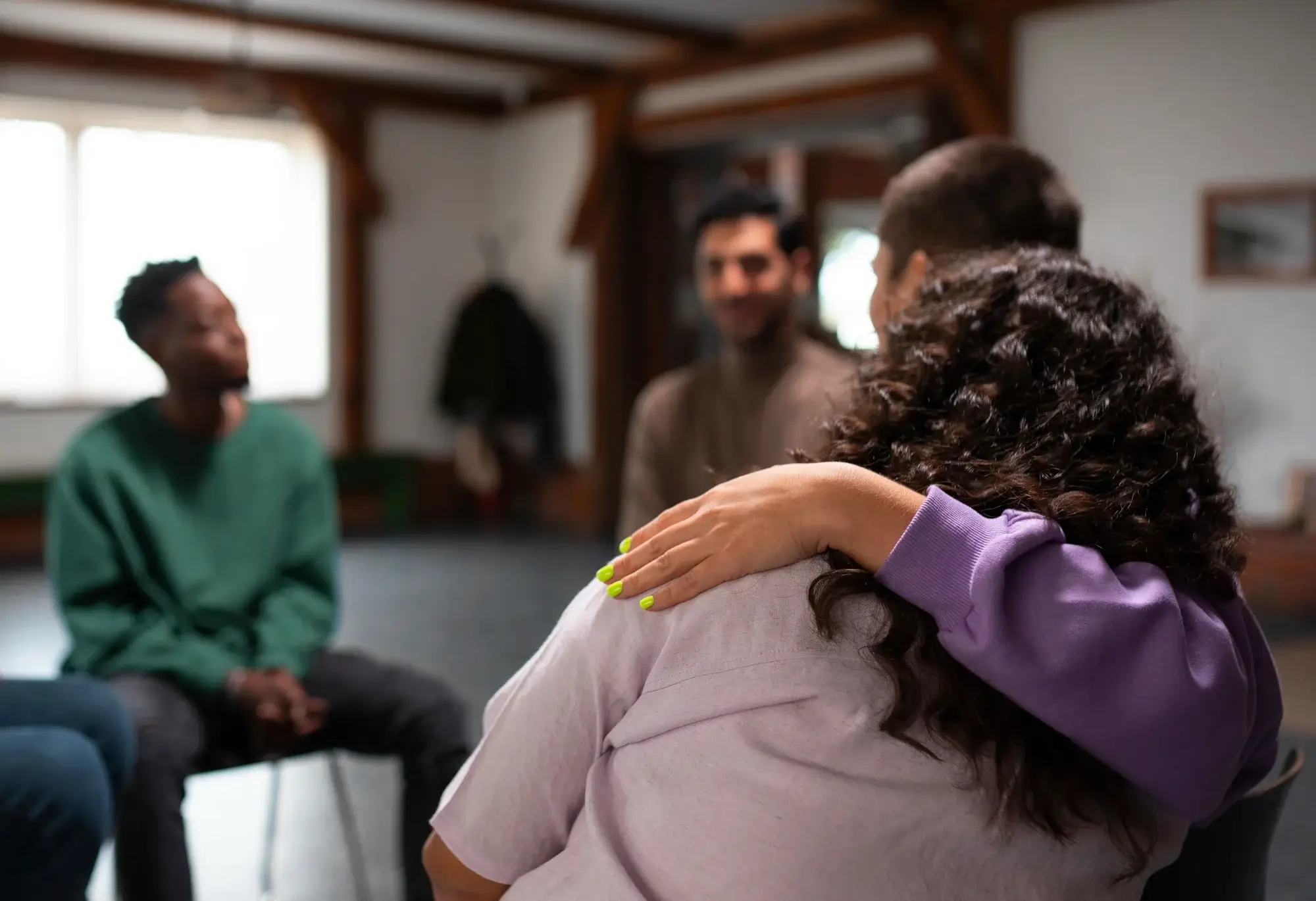 A comforting hand resting on a shoulder illustrates the compassionate support found in heroin detox in Sedalia, MO.