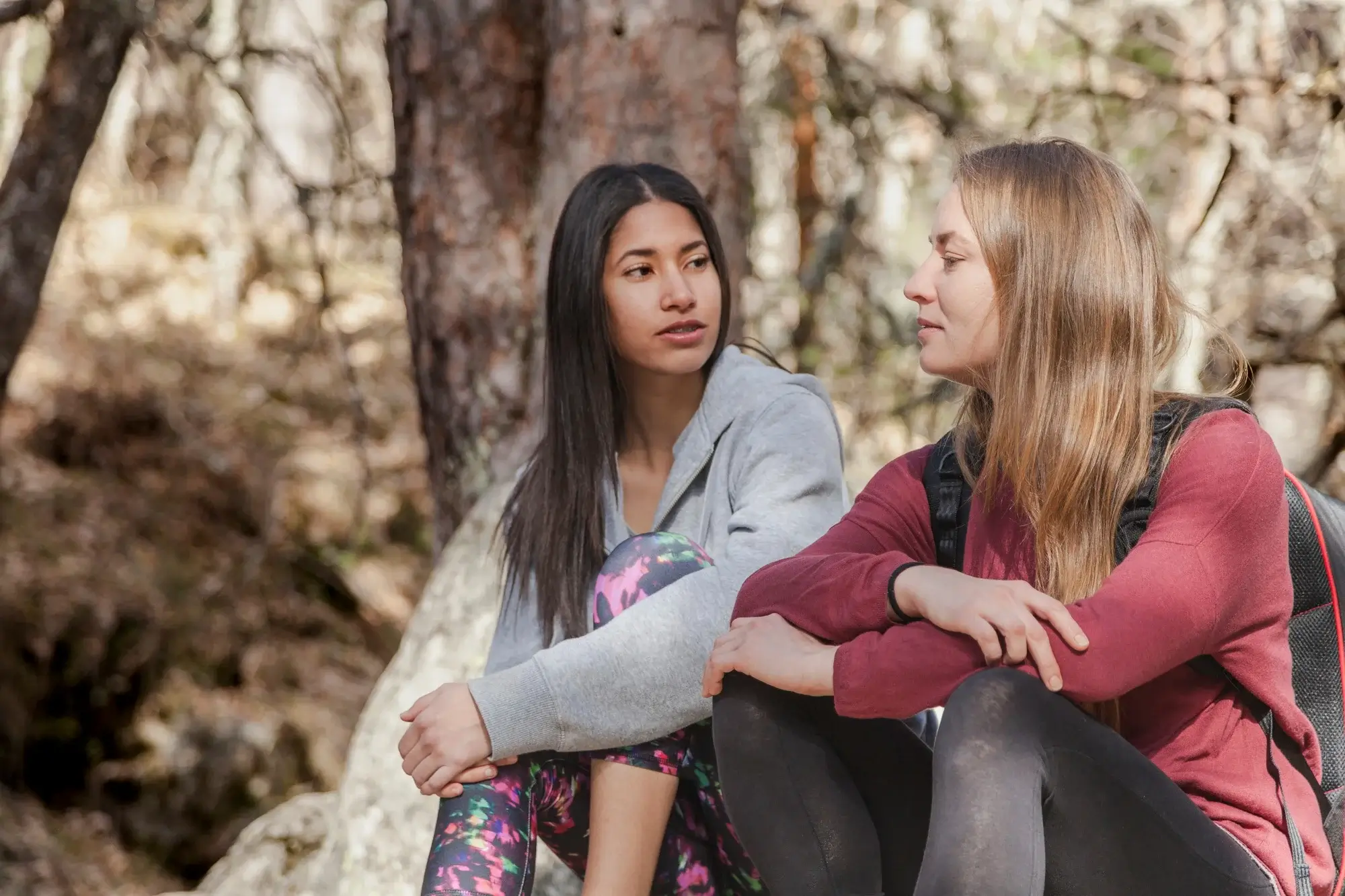 A young woman sitting outdoors looks contemplative, highlighting the need for marijuana addiction treatment in Missouri.