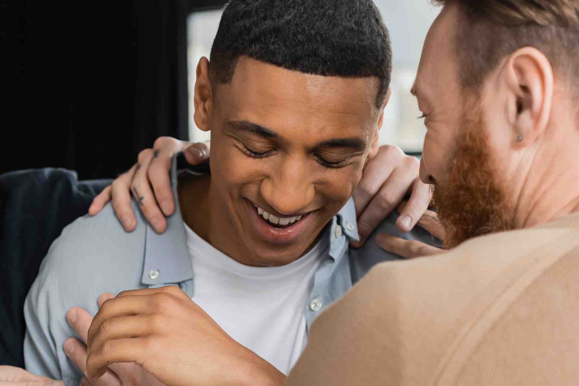 Men offering peer encouragement during addiction recovery meeting