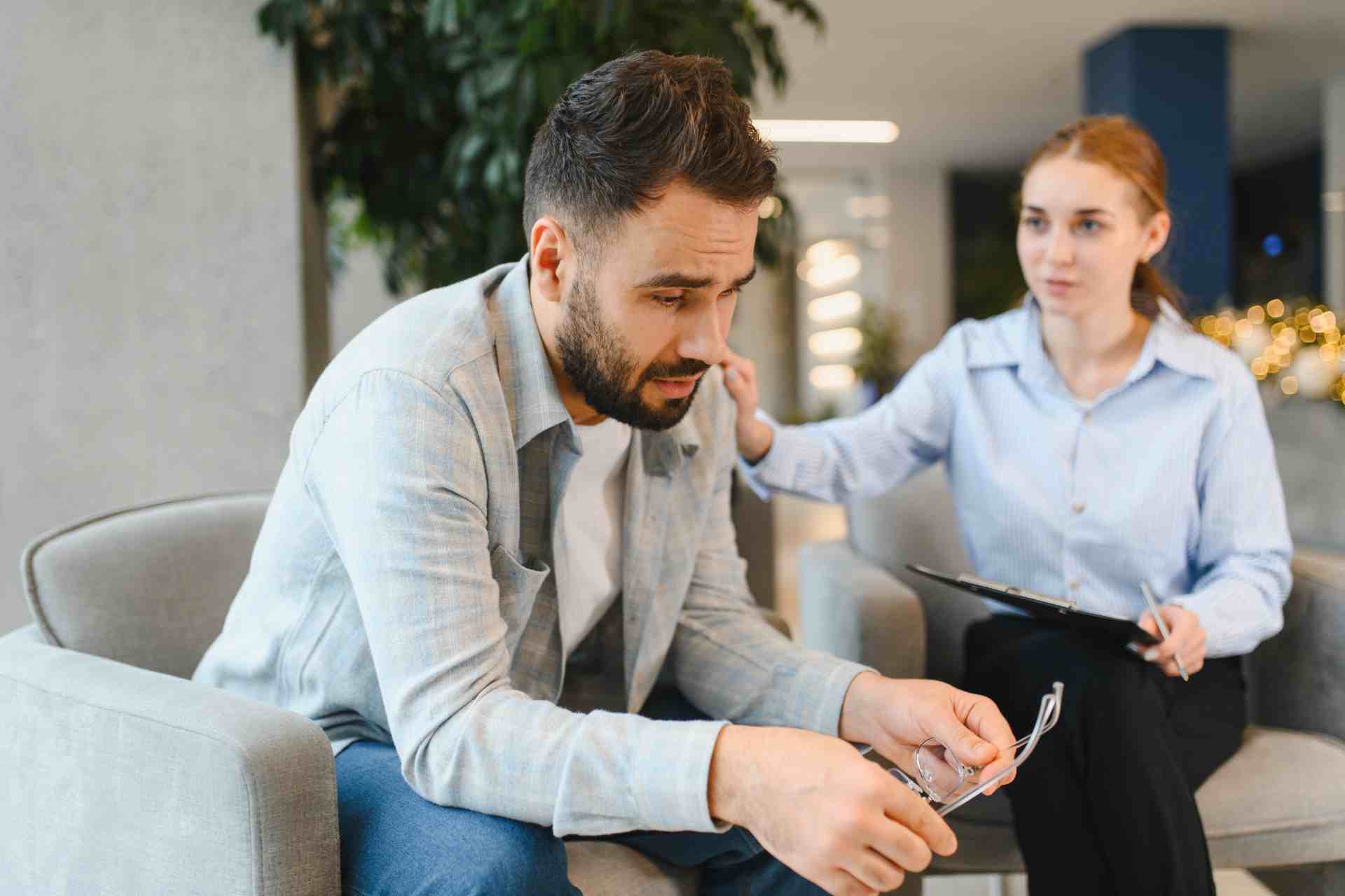 Man receiving support from a therapist during a mental health counseling session