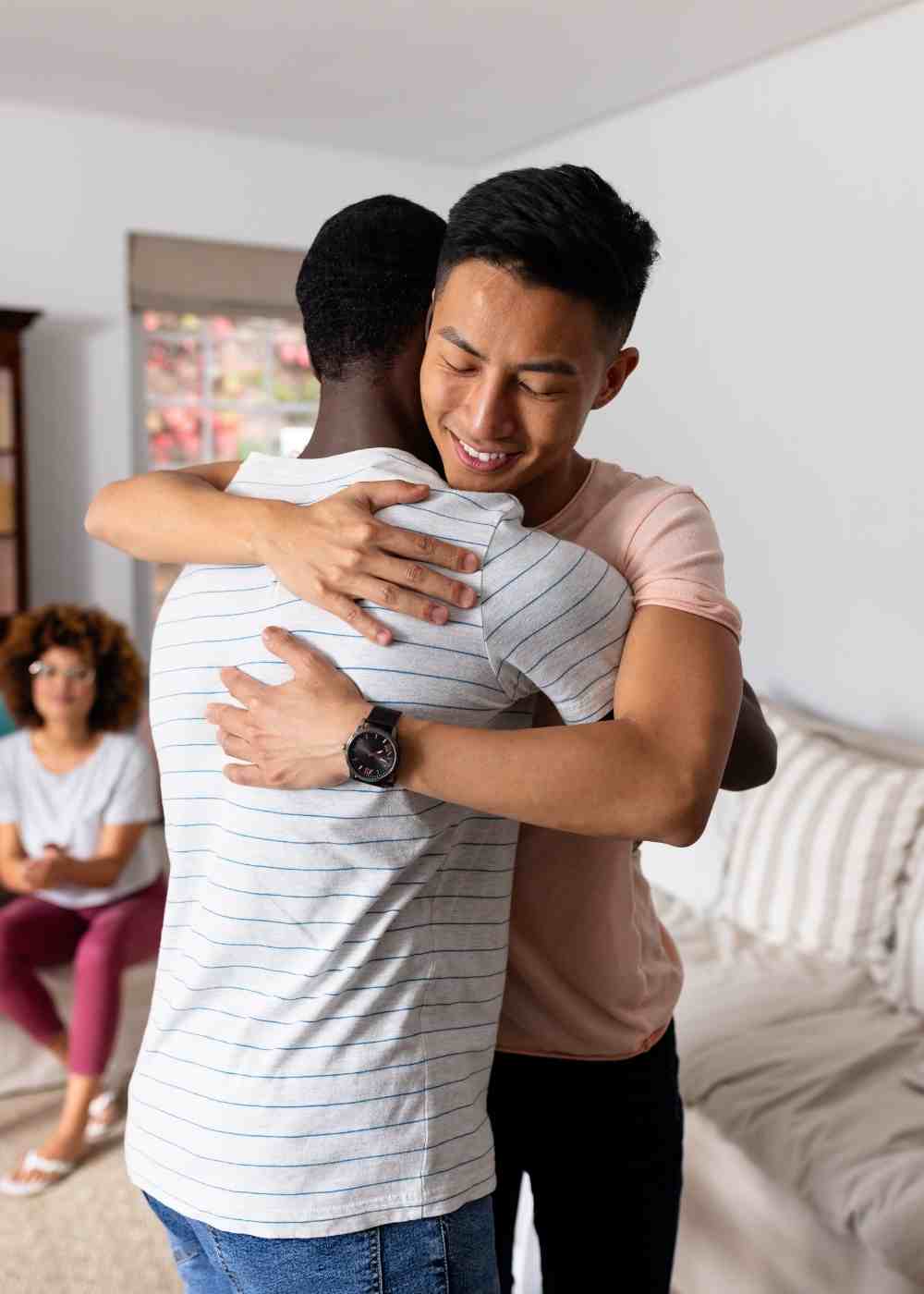 Two men hugging in support during addiction recovery