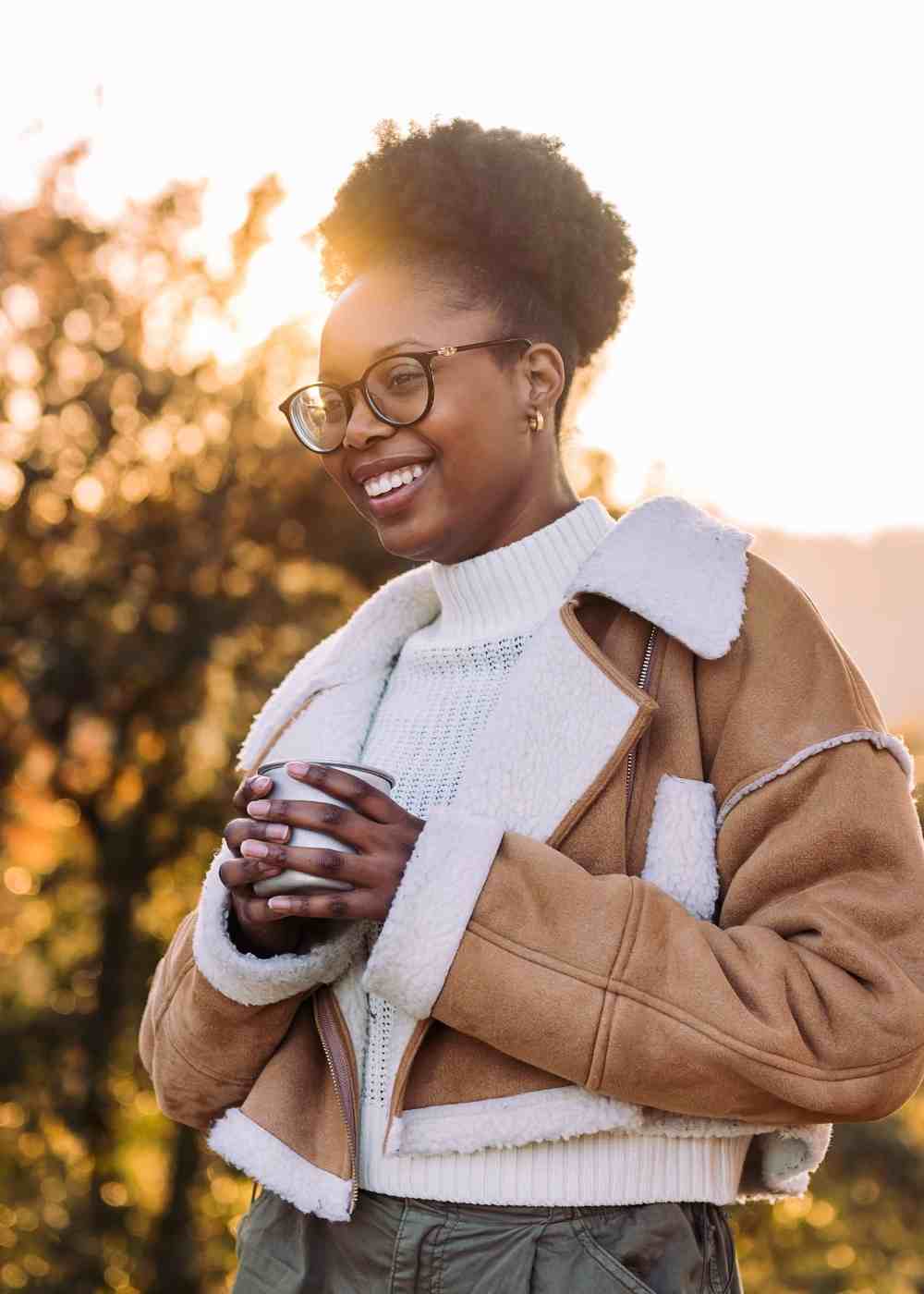 Woman smiling outdoors representing healthy lifestyle after Xanax addiction recovery