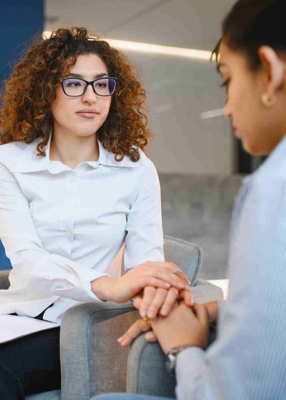 Mental health counselor comforting a woman during a supportive therapy session