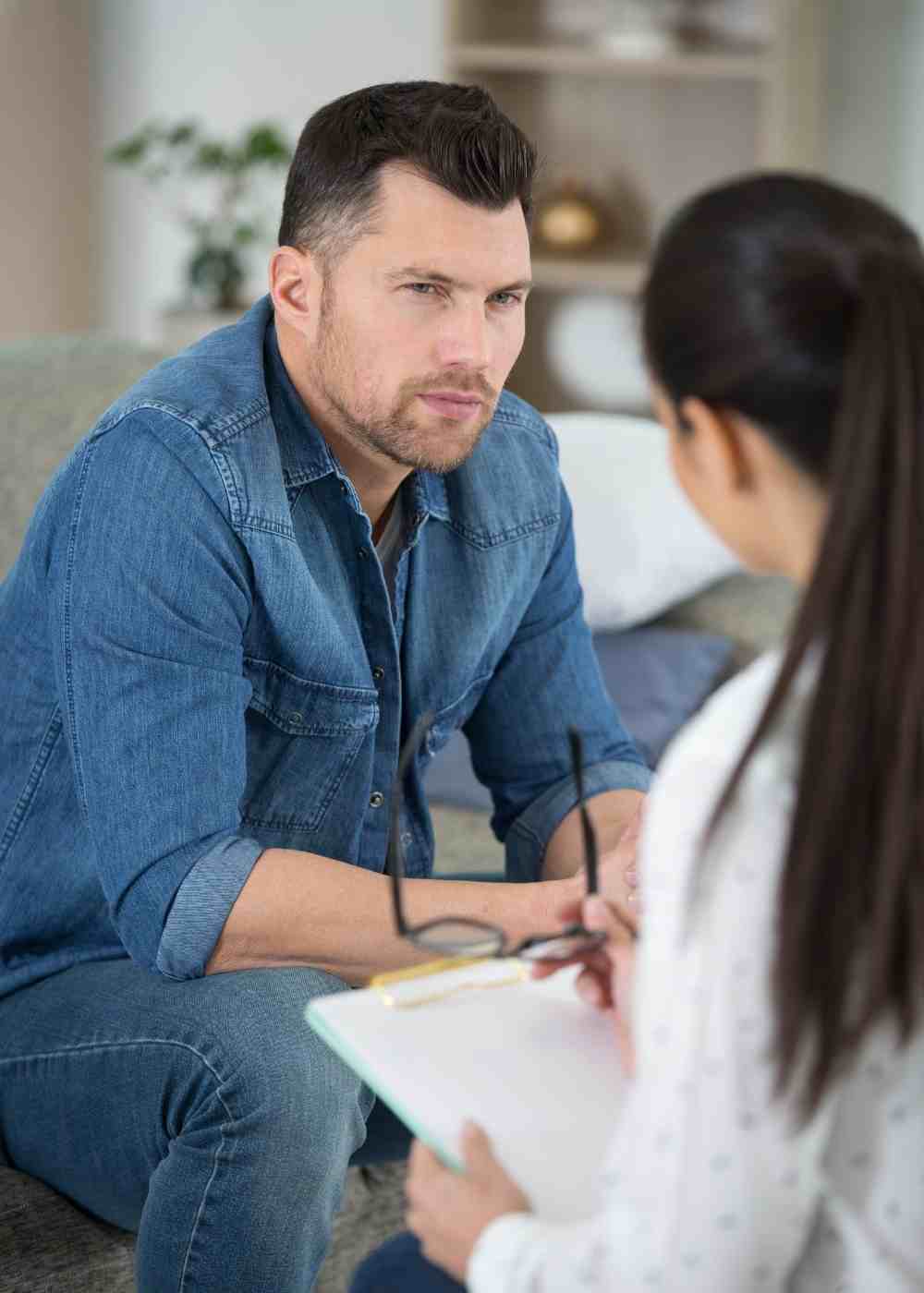 Man speaking with a therapist during a drug addiction treatment consultation