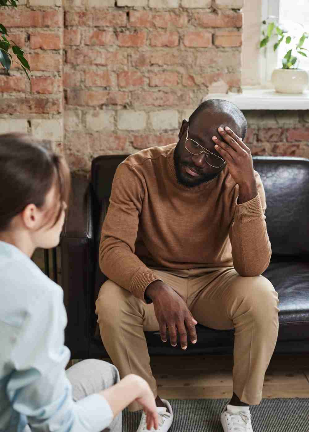 Man speaking with a therapist while experiencing emotional distress during counseling