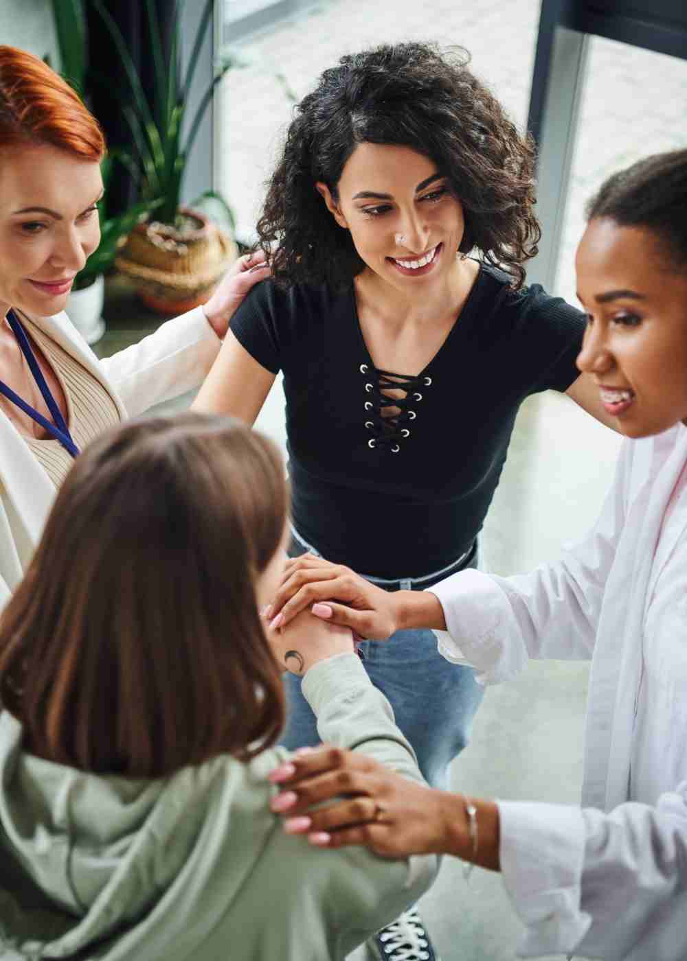 Mental health support group participants encouraging one another during a therapy session