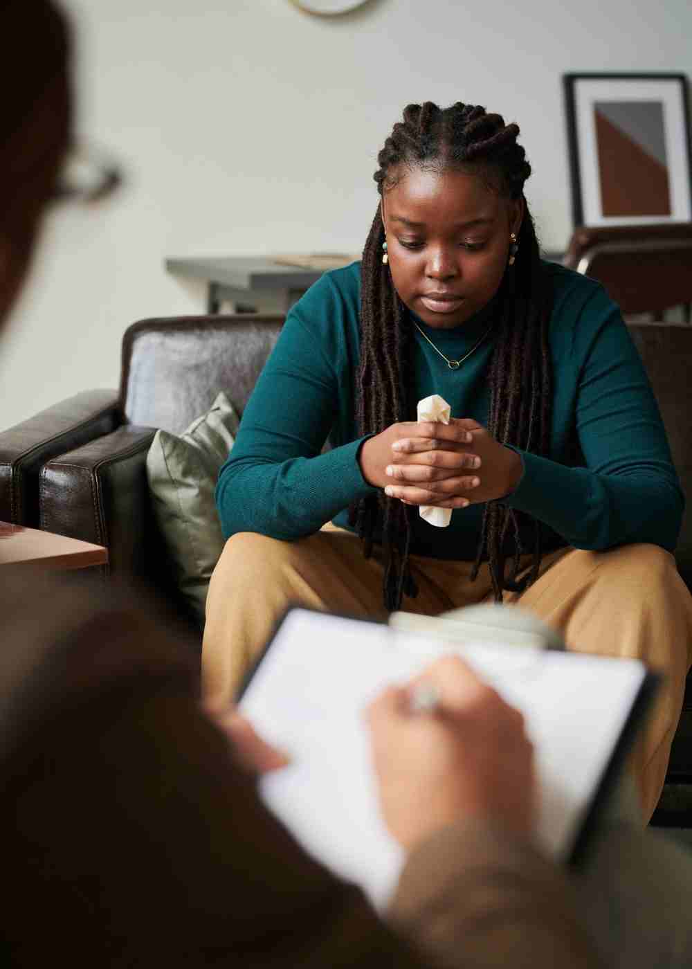 Woman receiving one-on-one counseling while discussing symptoms of depression with a mental health therapist