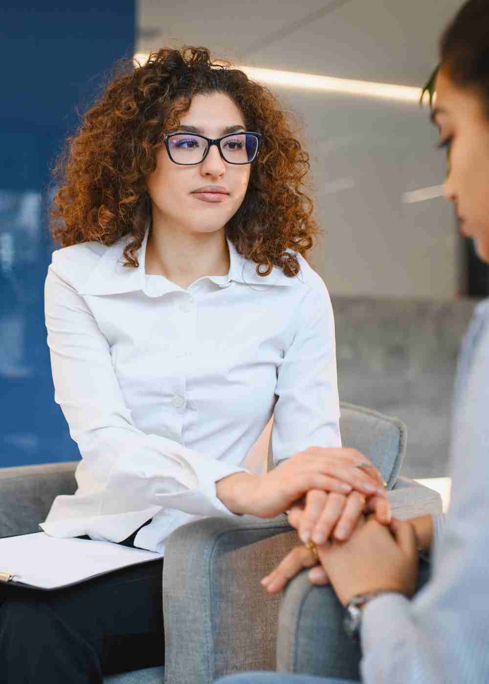 Therapist providing compassionate one-on-one counseling to a client during an individual addiction therapy session