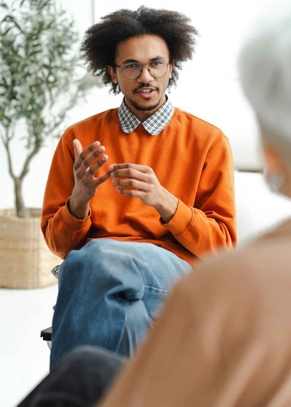 Man participating in group counseling for opioid addiction recovery